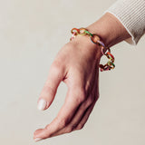 image of firework gold chain bracelet on model wrist with hand facing down