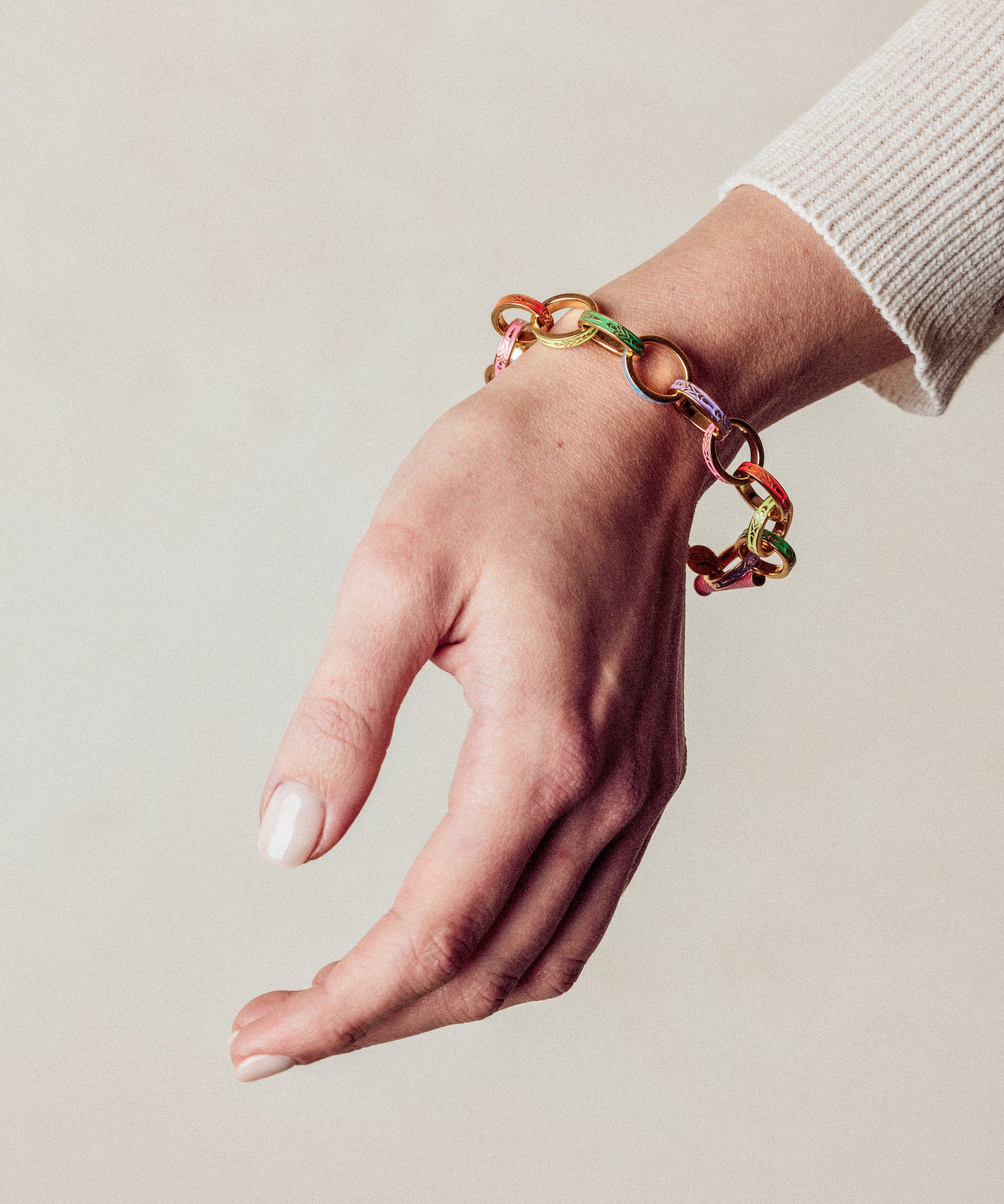 image of firework gold chain bracelet on model wrist with hand facing down