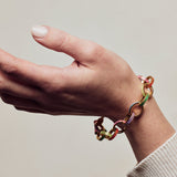 image of firework gold chain bracelet on model wrist with hand facing up