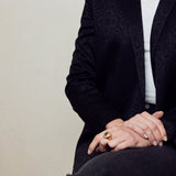 image of firework heart ring on model sitting with legs crossed and hands on lap