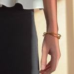 Ruddock-Soma-Bangle-Cuff-Interlocking-Interwoven-Tublar-Scultpural-twisted-clean-lines-forms-modern-statement-bracelet-Sleek-minimal-cool-jewellery-demifine-gold-plated-18ct