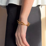 Ruddock-Soma-Bangle-Cuff-Interlocking-Interwoven-Tublar-Scultpural-twisted-clean-lines-forms-modern-statement-bracelet-Sleek-minimal-cool-jewellery-demifine-gold-plated-18ct