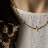 Gold vermeil necklace with 3 spikes on a ball chain. Worn with a white top and animal print bomber jacket