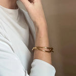 Ruddock-Soma-Bangle-Cuff-Interlocking-Interwoven-Tublar-Scultpural-twisted-clean-lines-forms-modern-statement-bracelet-Sleek-minimal-cool-jewellery-demifine-gold-plated-18ct
