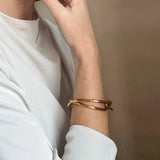Ruddock-Soma-Bangle-Cuff-Interlocking-Interwoven-Tublar-Scultpural-twisted-clean-lines-forms-modern-statement-bracelet-Sleek-minimal-cool-jewellery-demifine-gold-plated-18ct