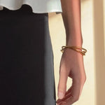 Ruddock-Soma-Bangle-Cuff-Interlocking-Interwoven-Tublar-Scultpural-twisted-clean-lines-forms-modern-statement-bracelet-Sleek-minimal-cool-jewellery-demifine-gold-plated-18ct