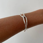 Ruddock-Soma-Bangle-Cuff-Interlocking-Interwoven-Tublar-Scultpural-twisted-clean-lines-forms-modern-statement-bracelet-Sleek-minimal-cool-jewellery-demifine-gold-plated-18ct
