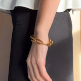 Ruddock-Soma-Bangle-Cuff-Interlocking-Interwoven-Tublar-Scultpural-twisted-clean-lines-forms-modern-statement-bracelet-Sleek-minimal-cool-jewellery-demifine-gold-plated-18ct
